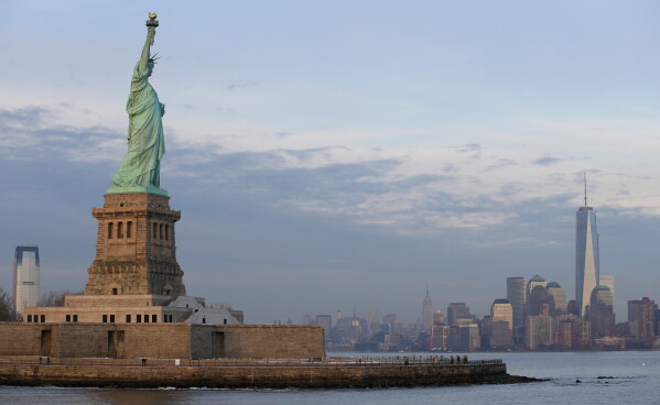 The lower Manhattan skyline, including the new One World Trade Center building at right, is shown as viewed from near the Statue of Liberty, Jan. 31, 2014, in New York. (AP Photo/Ted S. Warren, File)