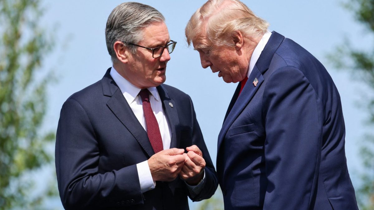 Britain's Prime Minister Keir Starmer and US President Donald Trump speak during a family photograph during the G7 summit, in Evian, eastern France, on June 16, 2026. A G7 summit is set to take place June 15 to 17 in the French town of Evian-les-Bains near Switzerland and it will be attended by country leaders as well as the EU's foreign policy chief and ministers from Brazil, Canada, the United Arab Emirates and Turkey. (Photo by Ludovic MARIN / POOL / AFP via Getty Images)