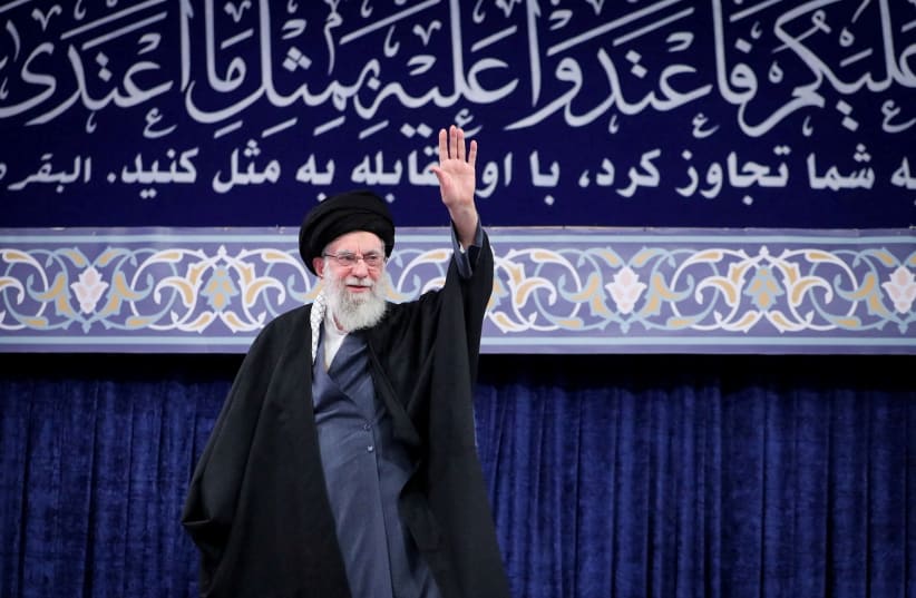 Iran's former supreme leader Ayatollah Ali Khamenei waves during a meeting in Tehran, Iran, February 17, 2026.