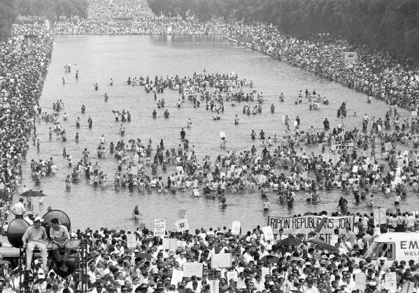 Many supporters of the Poor People's Campaign wade into the Reflecting Pool during the Solidarity Day program at the Lincoln Memorial in Washington June 19, 1968. (AP Photo)