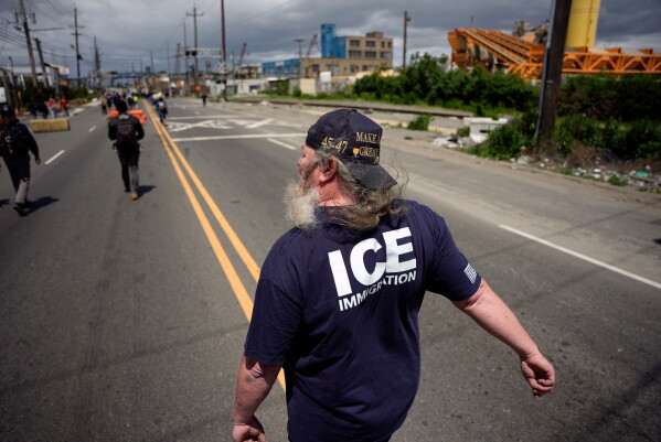 A protester supporting Immigration and Customs Enforcement agents walks on the road outside the Delaney Hall detention center on Saturday, May 30, 2026, in Newark, N.J. (AP Photo/Angelina Katsanis)