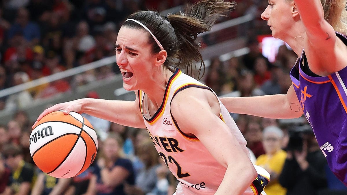 Caitlin Clark dribbling basketball defended by Lexi Held at Gainbridge Fieldhouse
