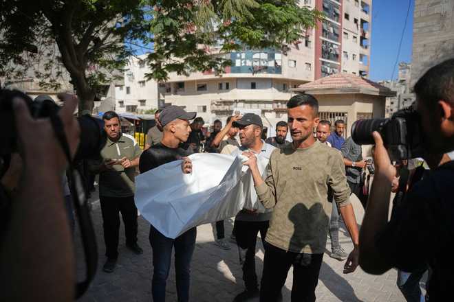 Mourners carry the bodies Mourners carry the bodies of two Palestinian girls Zeina Safadi, and her sister Lana, who were killed during an overnight Israeli airstrike that damaged their home, during their funeral in Gaza City, Saturday, June 20, 2026.