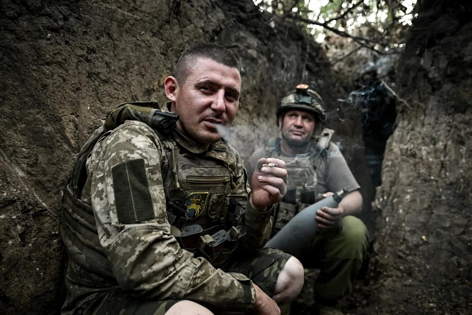 Ukrainian artillerymen await orders in a trench in Donetsk