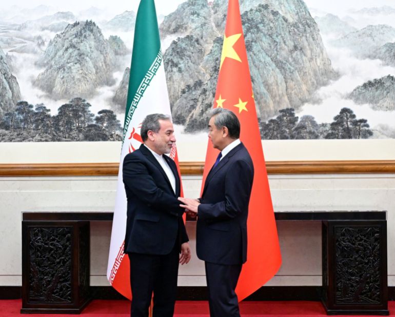 Chinese Foreign Minister Wang Yi and Iranian Foreign Minister Abbas Araqchi shake hands in Beijing, China, in this handout image released by China's Ministry of Foreign Affairs May 6, 2026.