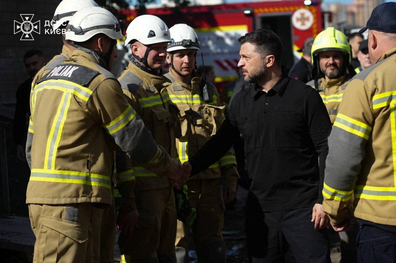 President Volodymyr Zelensky with emergency workers after a Russian missile and drone attack in Kyiv