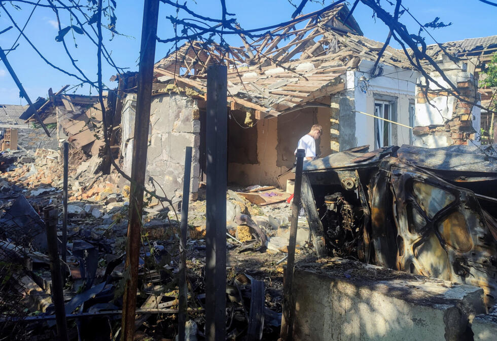 A resident stands at a site where a house was heavily damaged by a Russian drone strike, amid Russia's attack on Ukraine, in Mykolaiv, Ukraine June 12, 2026.