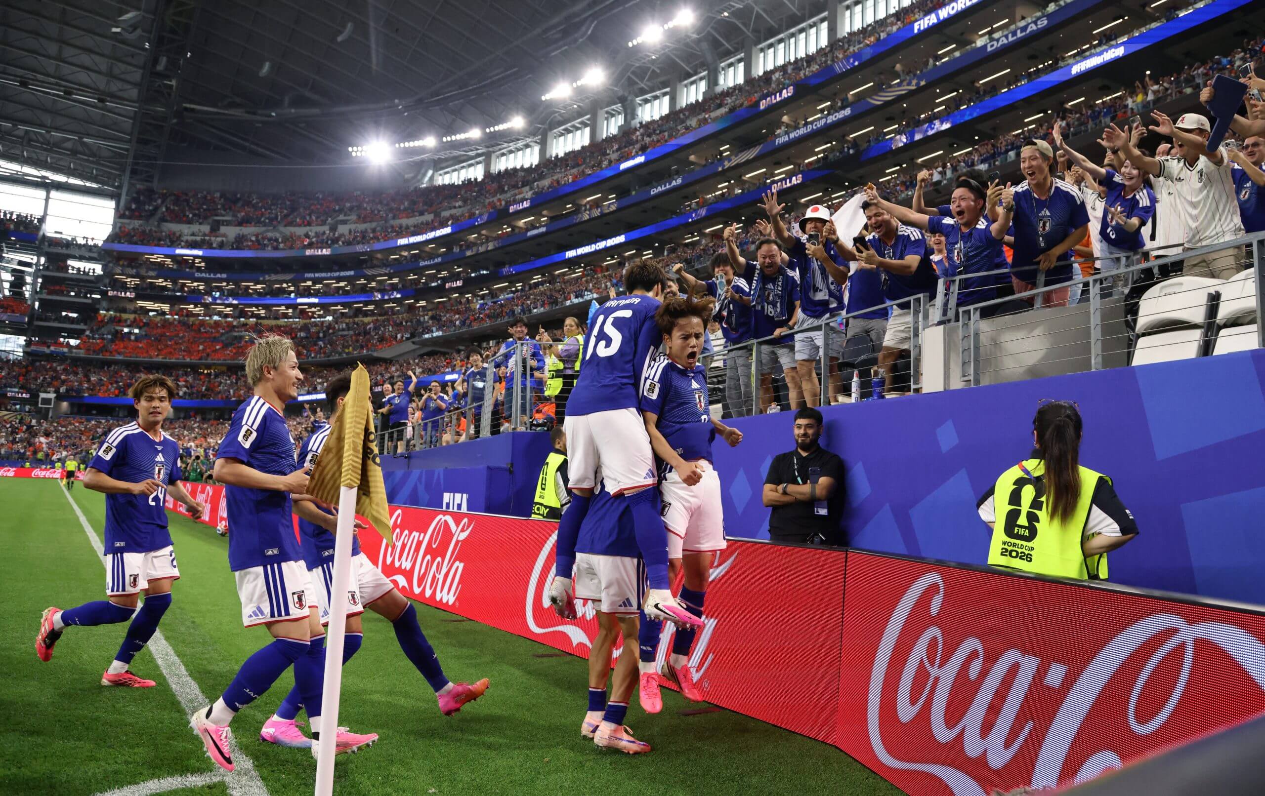 Japan's Keito Nakamura is mobbed by his team-mates after scoring the first of Japan's two equalisers