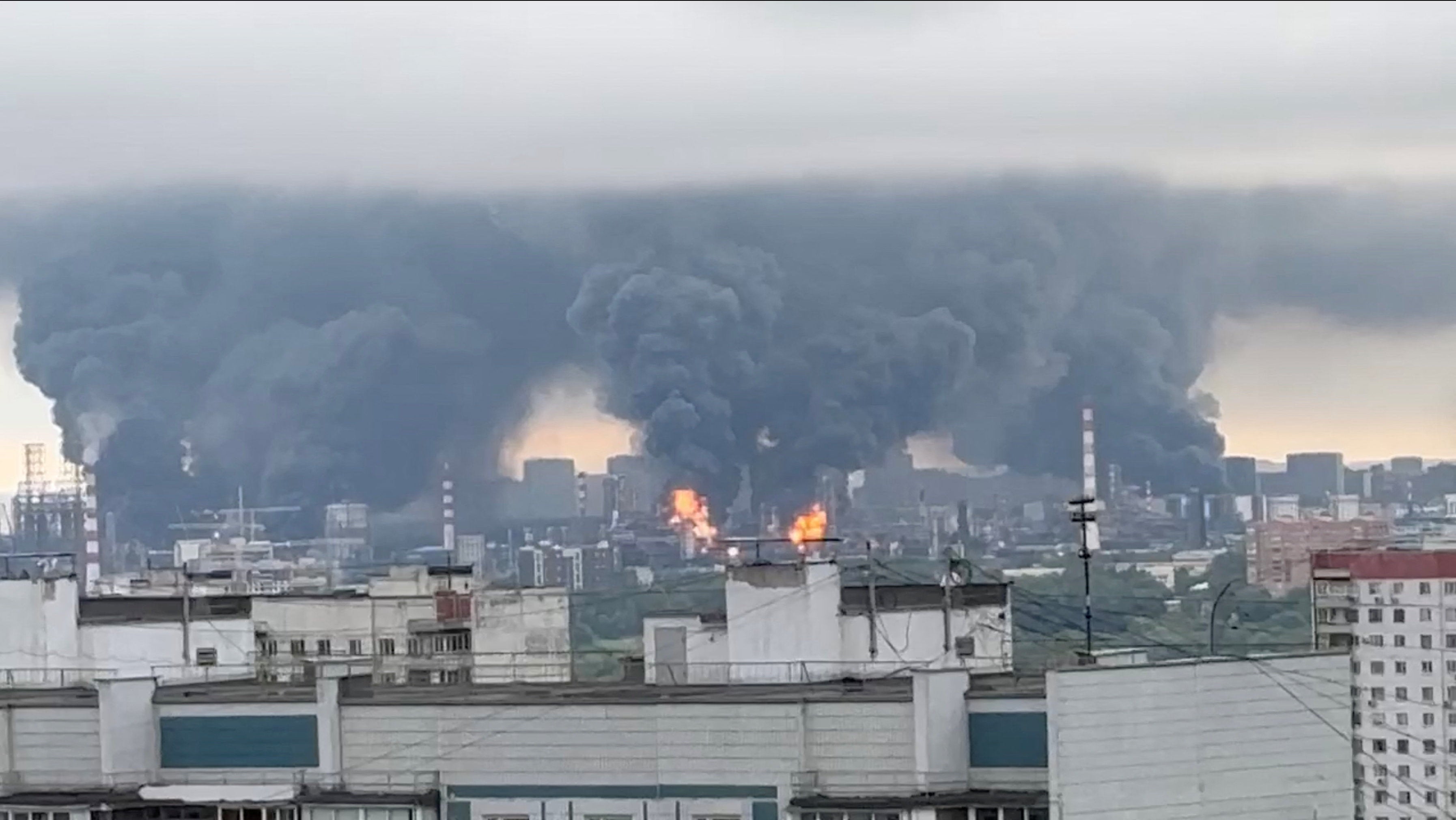 Thick plumes of smoke with flames rise from an oil refinery in Moscow