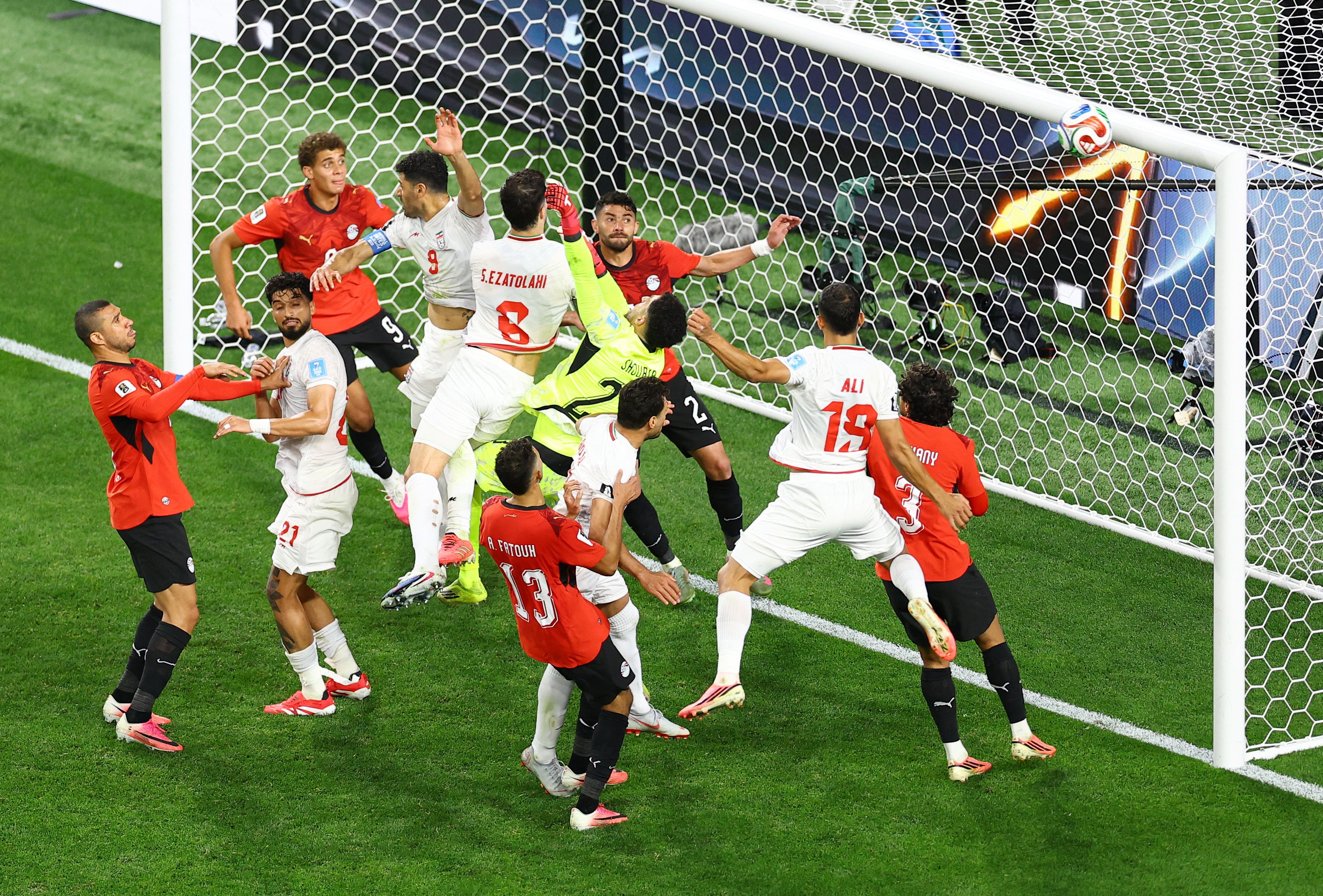 Iran's Saeid Ezatolahi, Mehdi Taremi and Ali Nemati in action as the ball hits the cross bar