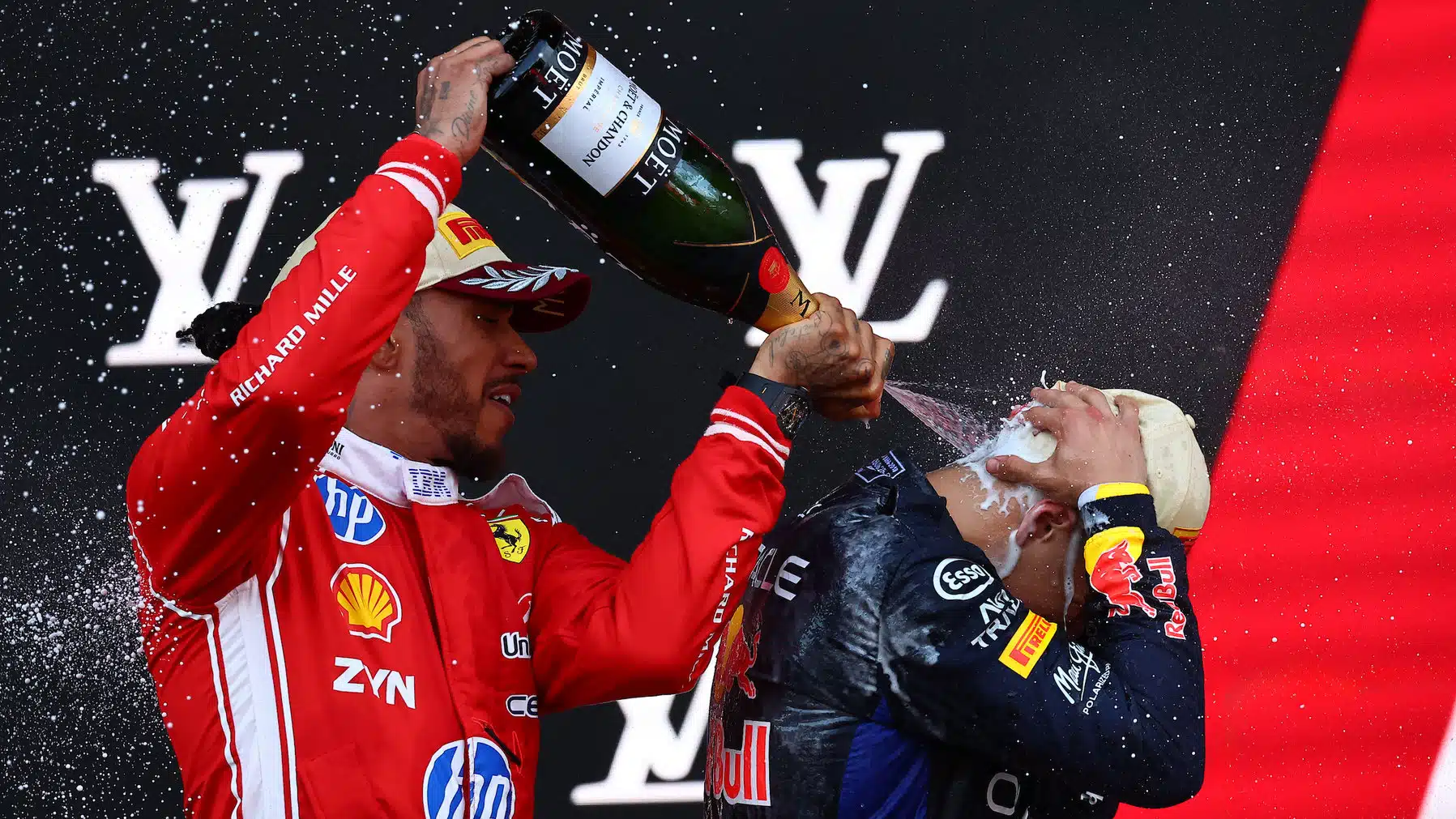 Lewis Hamilton (Ferrari) and Isack Hadjar (Red Bull-Ford) sprays the champagne after the 2026 Monaco Grand Prix
