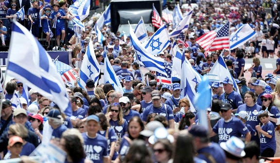 People hold Israeli and U.S. flags as they march during the "Israel Day on Fifth" parade in New York City, U.S., May 31, 2026.
