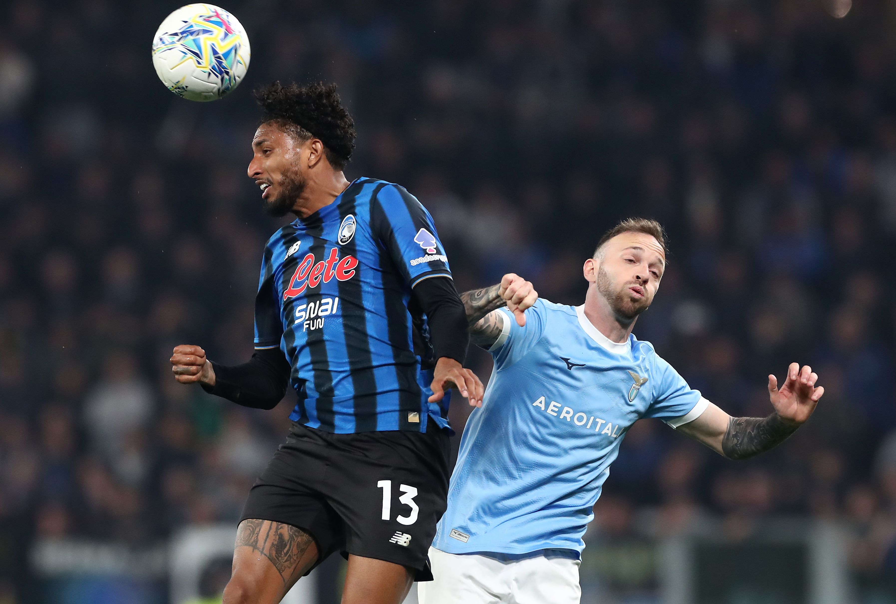 Ederson of Atalanta and Manuel Lazzari of Lazio jump for the ball