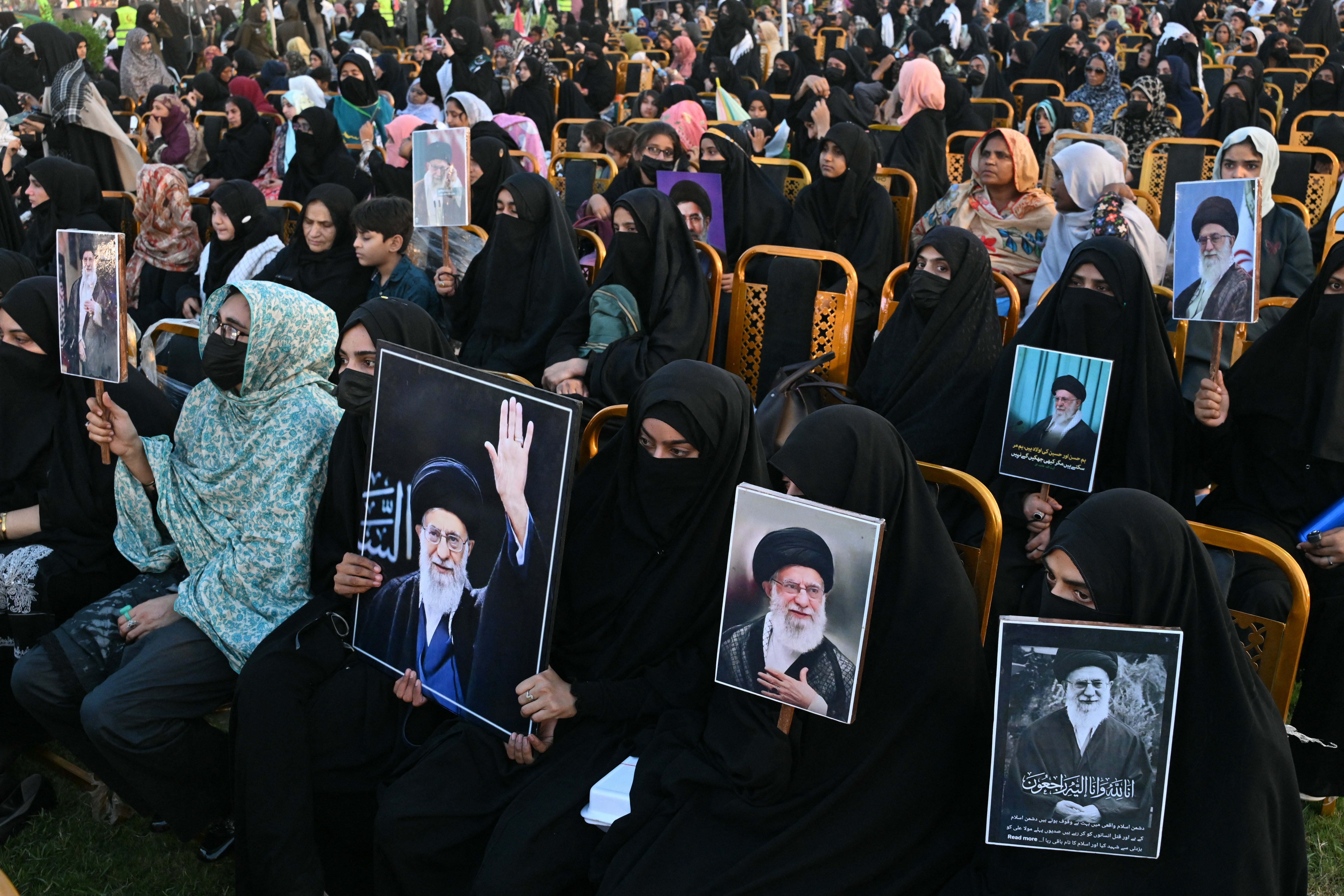 Activists carry portraits of Iran's slain supreme leader Ayatollah Ali Khamenei
