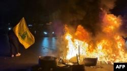 Hezbollah supporters block the old airport road in the southern suburbs of Beirut, with burning tires to protest against the trilateral agreement that was signed between the United States, Israel, and Lebanon on June 27.