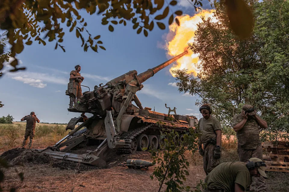 Ukrainian soldiers fire a heavy artillery system from a combat position in Donetsk Oblast