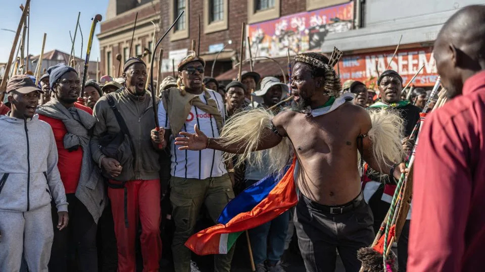 Nkosikhona Ndabandaba, in traditional Zulu dress, gives instructions to the crowd during a protest march against undocumented migrants in Springs, east of Johannesburg, on June 8. - Emmanuel Croset/AFP/Getty Images