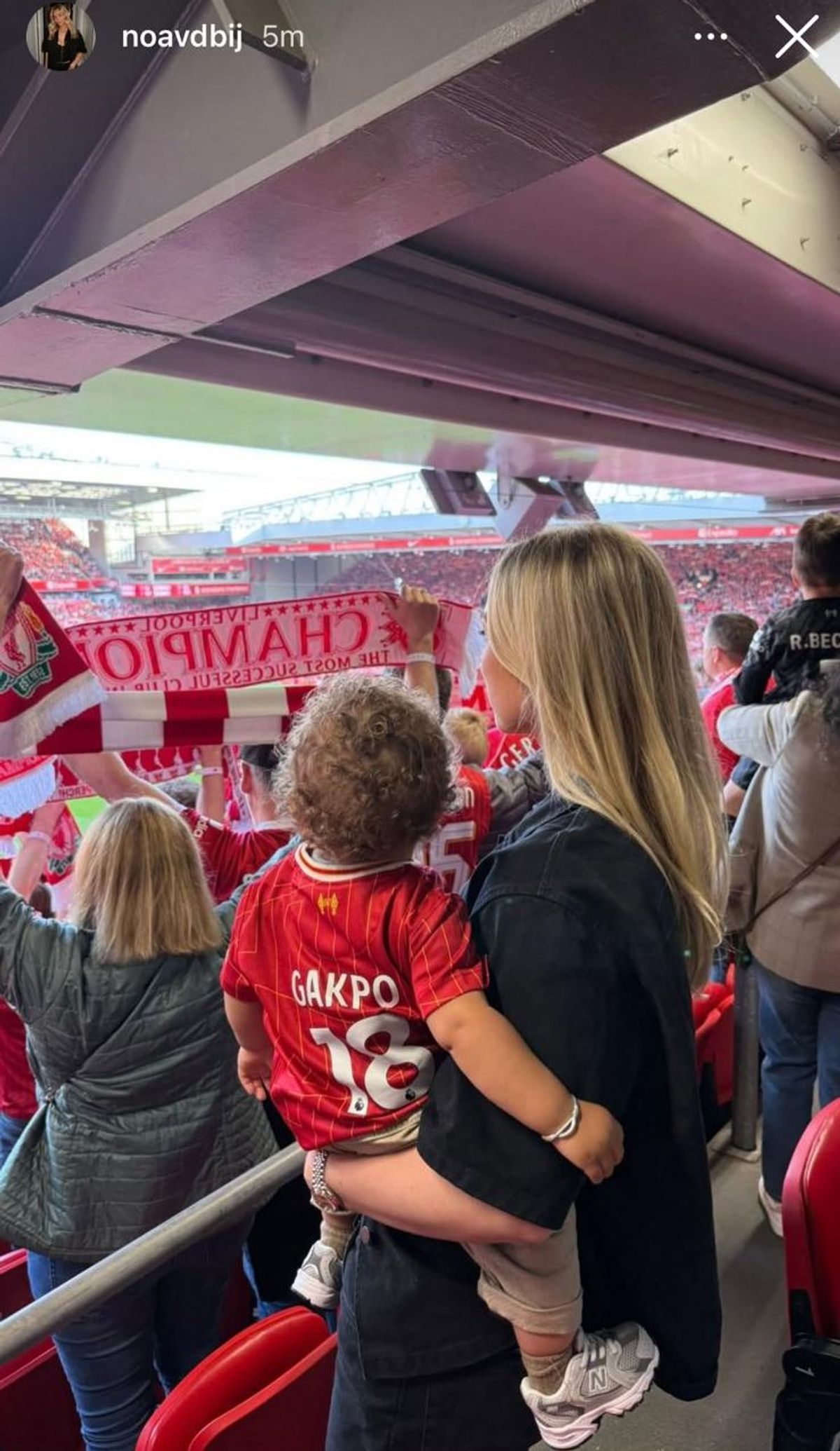 Noa with their son Samuël at Anfield