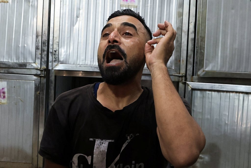 A Palestinian man mourns victims of an Israeli strike at Al-Shifa Hospital in Gaza City on Sunday. Photo: Reuters