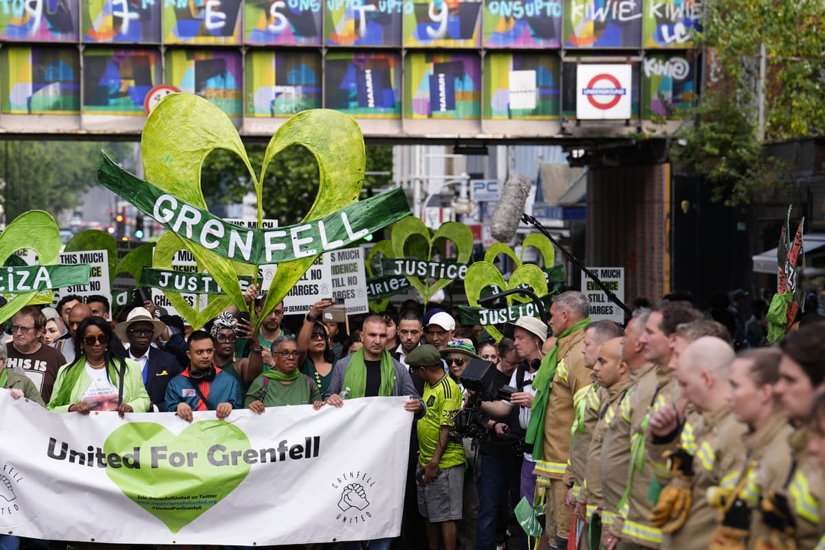 Grenfell demonstrators embrace firefighters during anniversary march - London Evening Standard