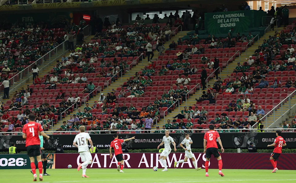 Soccer players for South Korea and the Czech Republic on the pitch.
