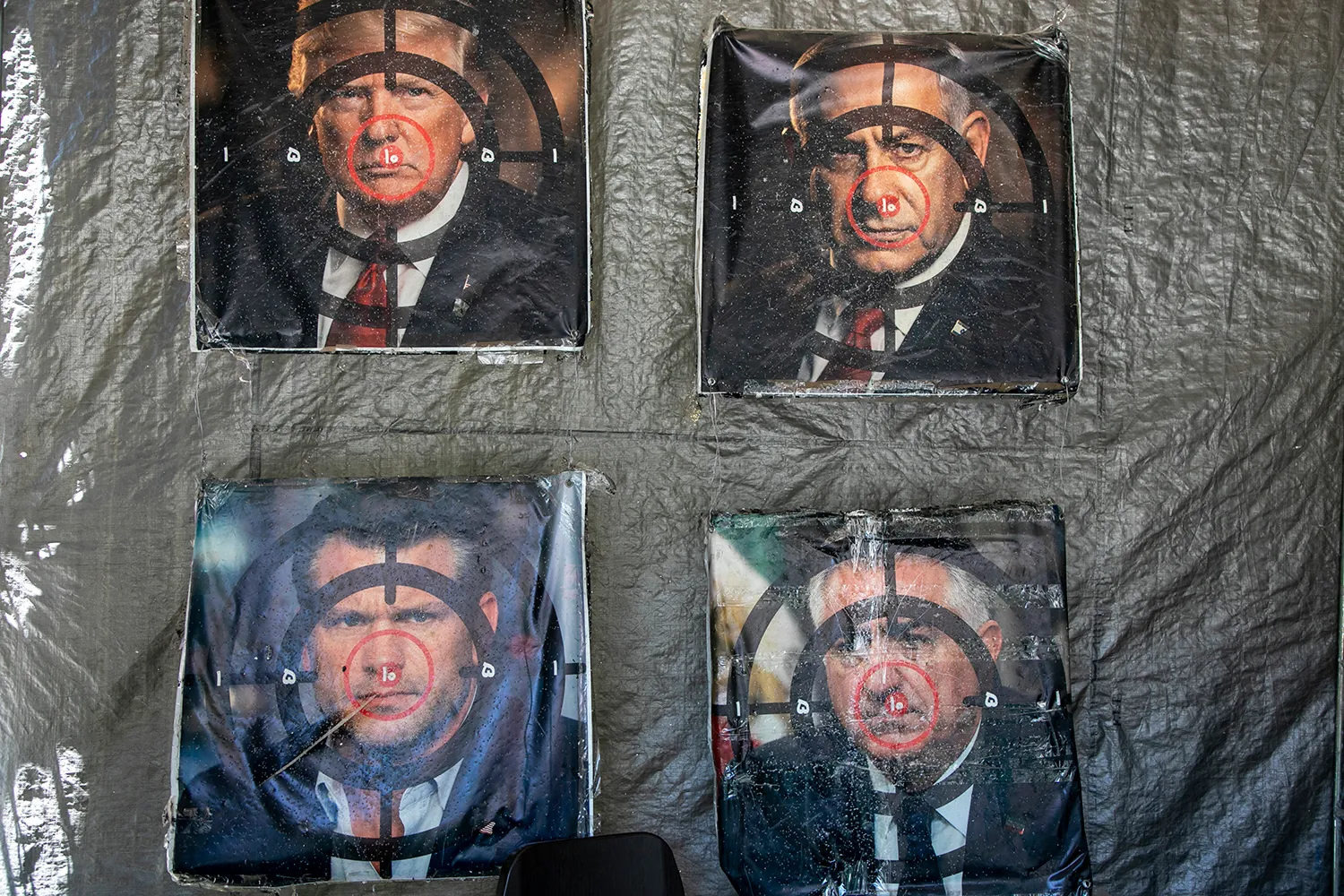Posters with images of Trump, Israeli Prime Minister Benjamin Netanyahu, and U.S. Defense Secretary Pete Hegseth as targets are seen hanging on a wall in Qom, Iran.