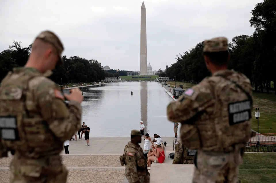 Members of the National Guard patrol as National Park Service workers clean algae from the Lincoln Memorial Reflecting Pool in Washington, Thursday, June 18, 2026. 