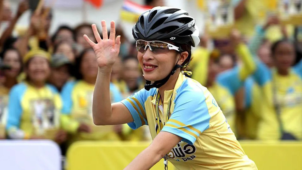 Thailand's Princess Bajrakitiyabha waves to the crowd as she cycles in the "Bike for Dad" event in Bangkok.