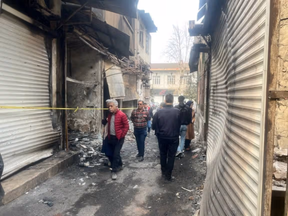 People walking at Rasht bazaar the day after the fire in January