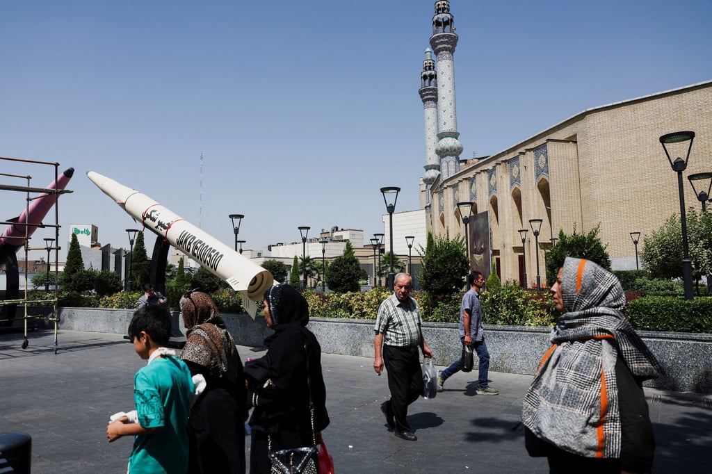 People walk next to a mock-up of an Iranian missile in Tehran on Thursday. Photo: Reuters
