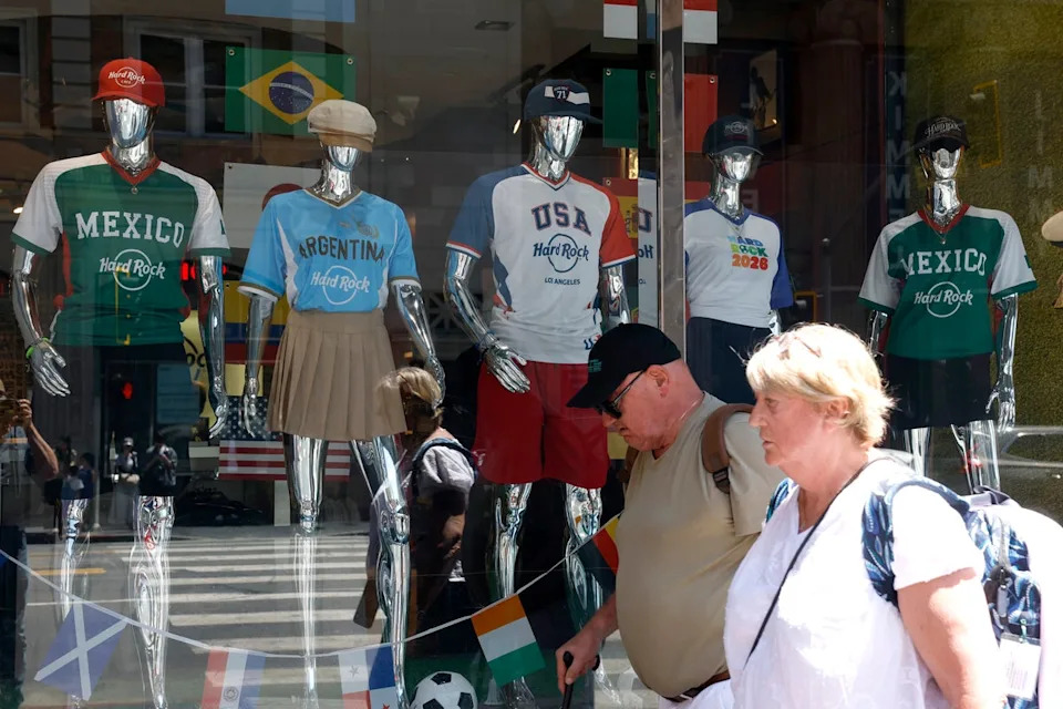 A pair of Americans walk past a display of World Cup jerseys in Santa Monica, California (Getty)