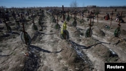 Graves of unidentified people killed by Russian soldiers during the occupation of Bucha, Ukraine, outside Kyiv