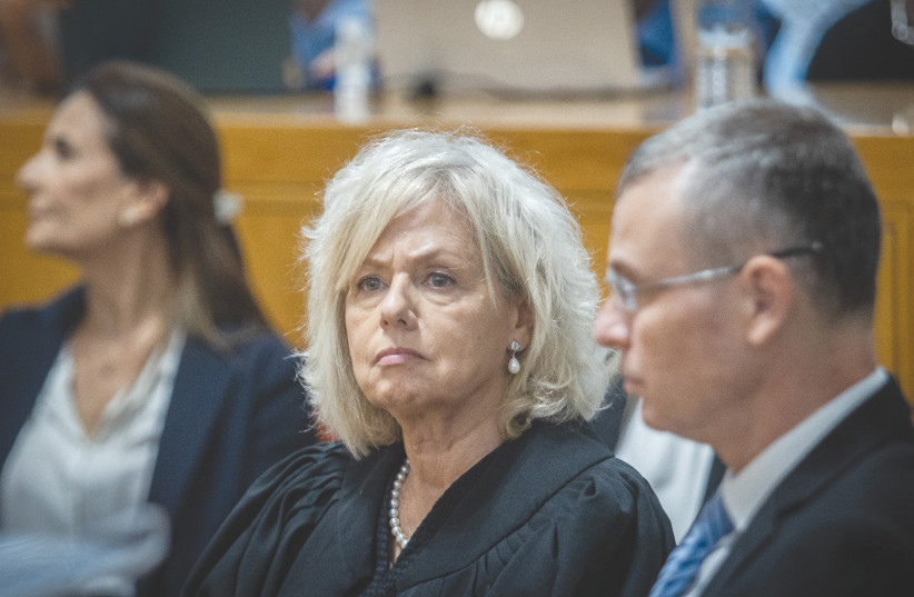 Attorney-General Gali Baharav-Miara sits next to Justice Minister Yariv Levin at a ceremony for retiring acting chief justice Uzi Vogelman, at the Supreme Court in Jerusalem, in October.