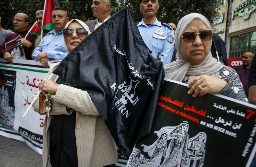 A WOMAN holds a placard that reads: ‘Palestine belongs to Palestinians; we will never leave,’ at a protest marking the 77th anniversary of the ‘Nakba’ in Hebron.