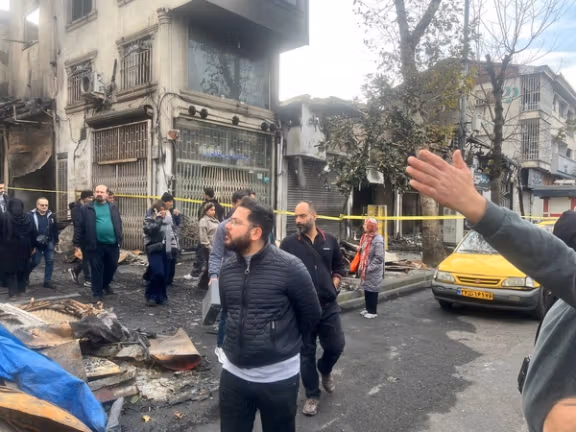 People walking at Rasht bazaar the day after the fire in January
