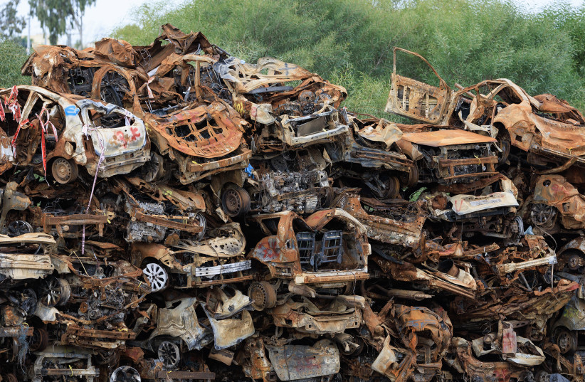 CARS SHOT at and burned in the Hamas attack of October 7, 2023, are later piled high at Tkuma, a moshav in the South.