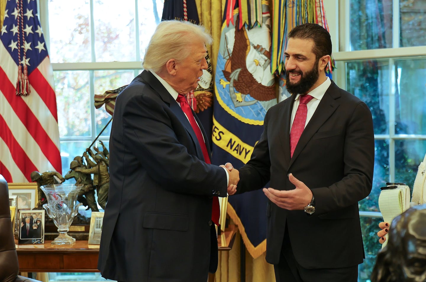 In this photo released by Syrian Presidency press office, President Trump, left, shakes hands with Syria's President Ahmad al-Sharaa, at the White House in Washington, on Nov. 10, 2025.