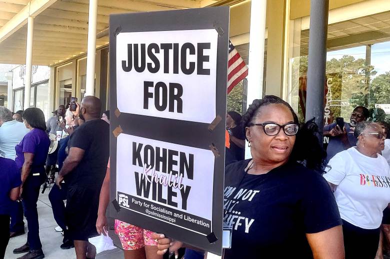 A woman in a crowd holds a sign that reads "JUSTICE FOR KOHEN KHALIL WILEY" "Party for Socialism and Liberation"