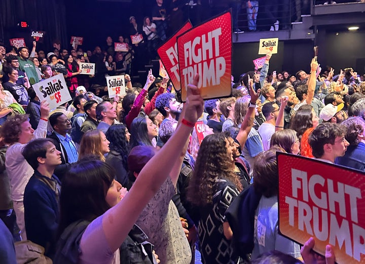 Supporters hold signs at a rally for Saikat Chakrabarti in May.