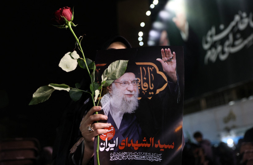 A woman holds a picture of Iran's slain supreme leader Ayatollah Ali Khamenei, in Tehran, Iran, March 9, 2026 (credit: MAJID ASGARIPOUR/WANA