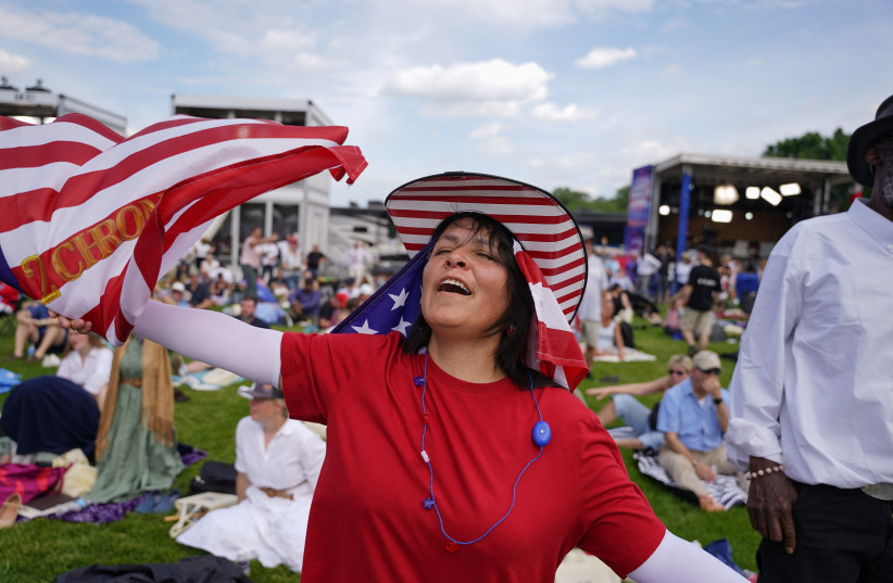 A woman participates in a worship service on the day of Rededicate 250: A National Jubilee of Prayer, Praise & Thanksgiving at the National Mall in Washington, D.C., U.S., May 17, 2026.