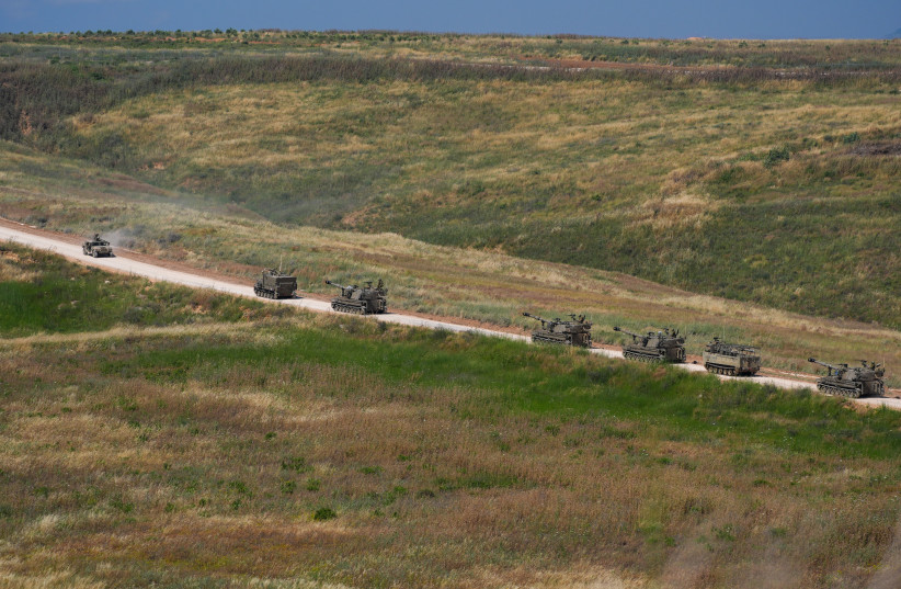 Israeli self-propelled artillery vehicles travel in a convoy toward southern Lebanon near the Israeli-Lebanese border, May 27, 2026.