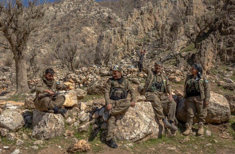Members of Komala of the Toilers of Kurdistan gather near a fortified position at a mountain base in Khalifan near Erbil, Iraq's Kurdistan region, on March 12, 2026.
