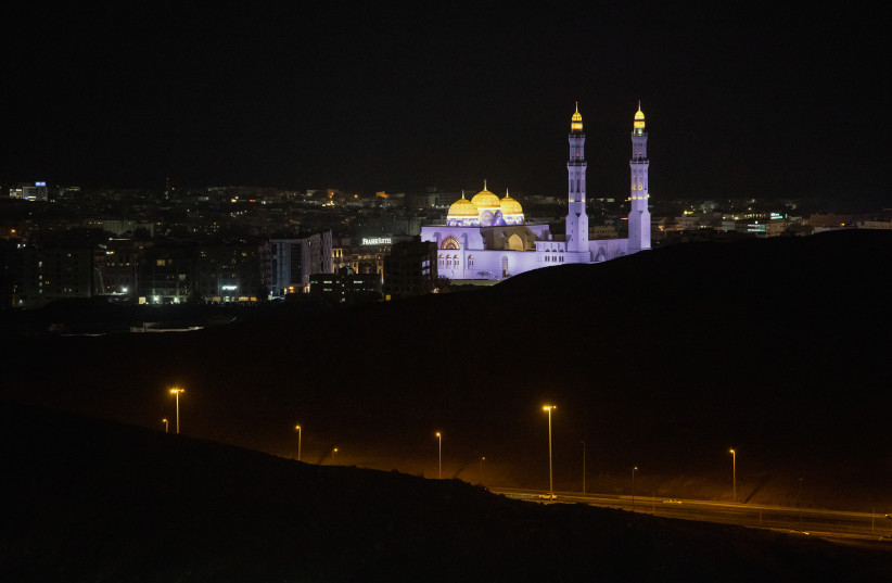 The Mohammed Al Ameen Mosque glows at night on March 22, 2026 in Muscat, Oman.