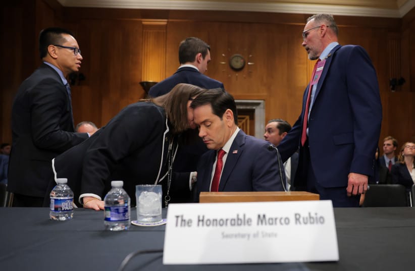 An aide speaks to US Secretary of State Marco Rubio as he prepares to testify during a Senate Foreign Relations Committee hearing in the Dirksen Senate Office Building on June 02, 2026 in Washington, DC.
