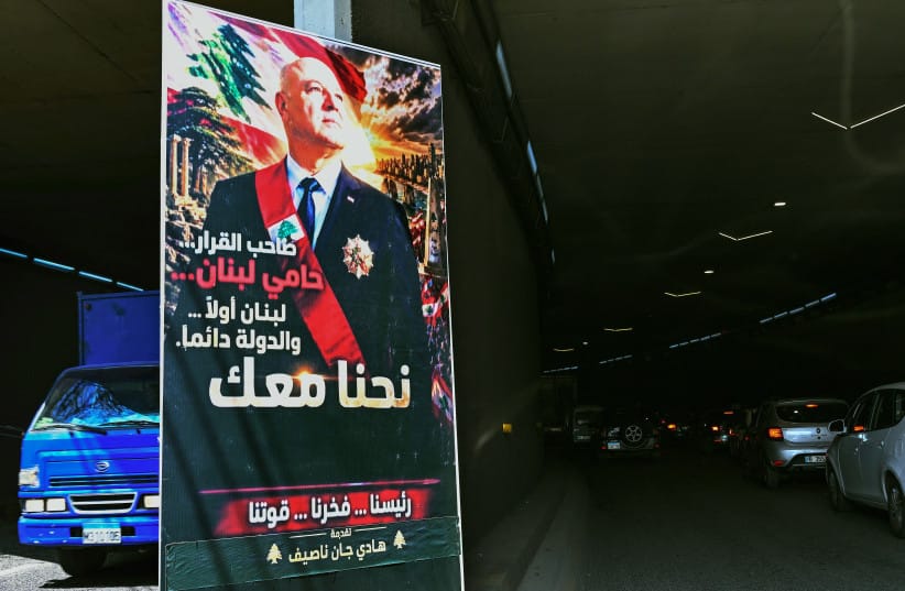 A poster depicting Lebanon's President Joseph Aoun that reads ''The decision-maker, the protector of Lebanon, Lebanon first...The State always. We are with you'' hangs at the entrance of a tunnel on a street in eastern Beirut on April 28, 2026.