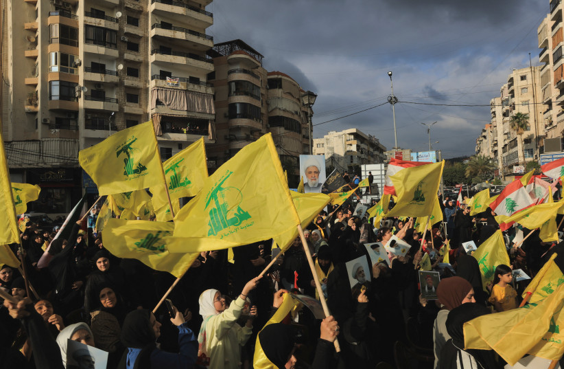 People hold Hezbollah flags while commemorating Israel’s withdrawal from southern Lebanon in 2000, in the southern suburbs of Beirut, Lebanon, May 25, 2026. (credit:  REUTERS/Raghed Waked)