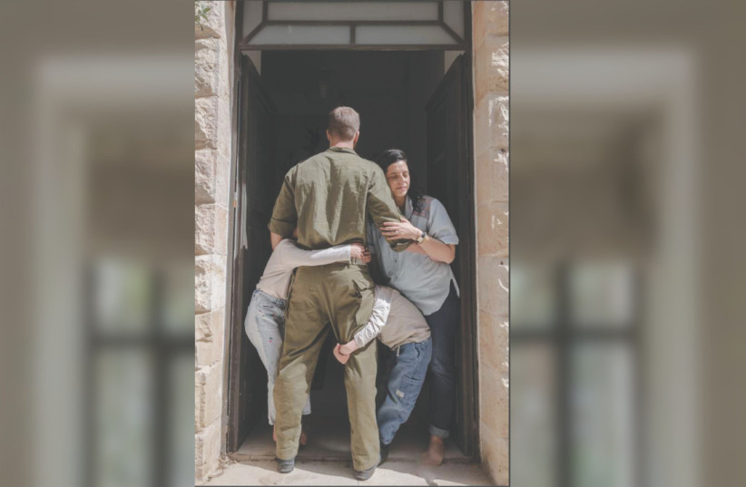 ‘I’M ALWAYS admiring him for putting his values in front. But I cannot pretend that it doesn’t create tension when our house is literally falling apart.’ Here, Yitzy hugs his family as he readies to depart.