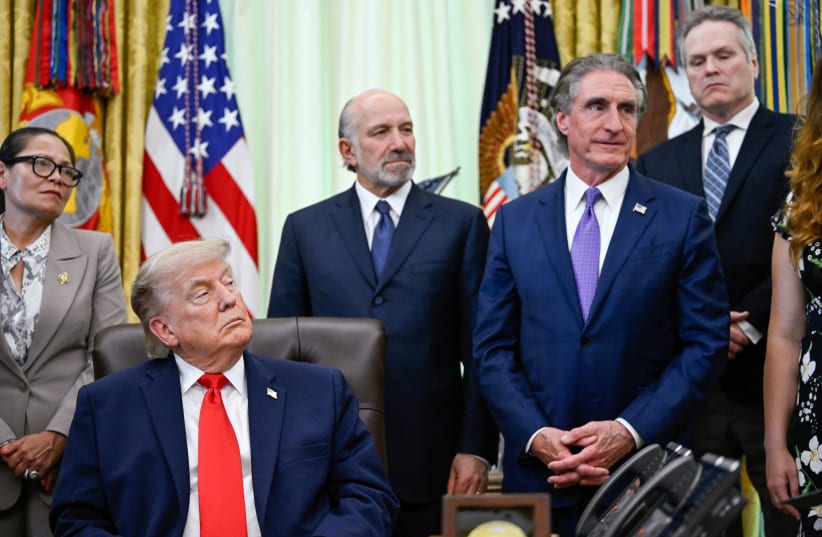 US President Donald Trump listens to an attendee in the Oval Office at the White House in Washington, DC, US, June 11, 2026. 