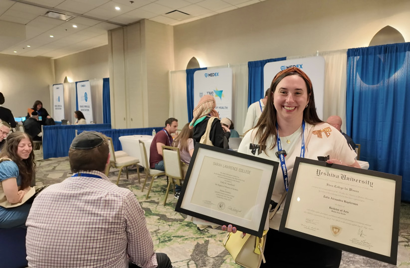 Genetic counselor, Talia Kupferman shows off her framed degrees taken from off the wall to bring to the MedEx event.